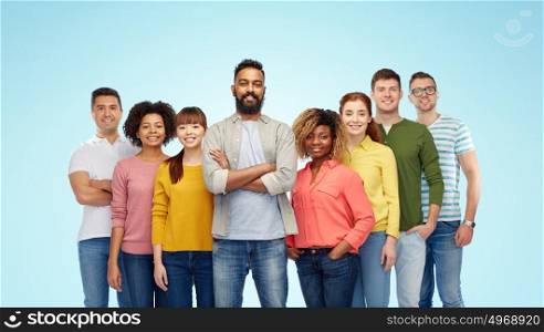diversity, race, ethnicity and people concept - international group of happy smiling men and women over blue background. international group of happy smiling people