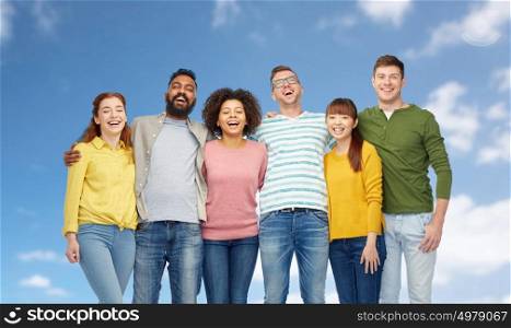 diversity, race, ethnicity and people concept - international group of happy smiling men and women over blue sky background. international group of happy people over blue sky