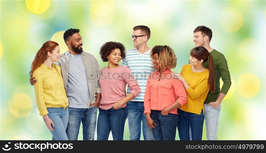 diversity, race, ethnicity and people concept - international group of happy smiling men and women over green holidays lights background. international group of happy smiling people