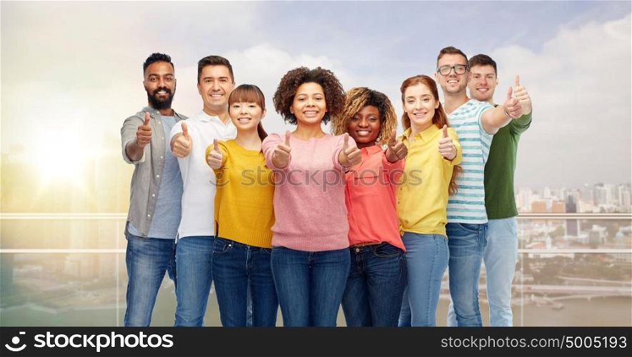 diversity, race, ethnicity and people concept - international group of happy smiling men and women showing thumbs up over singapore city background. international group of people showing thumbs up