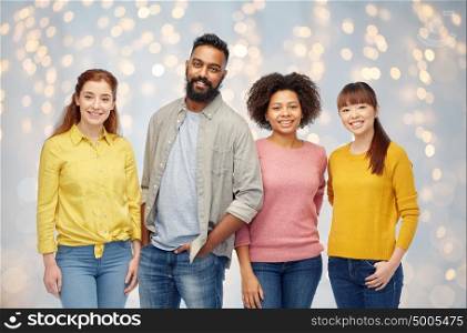 diversity, race, ethnicity and people concept - international group of happy smiling men and women over holidays lights background. international group of happy smiling people