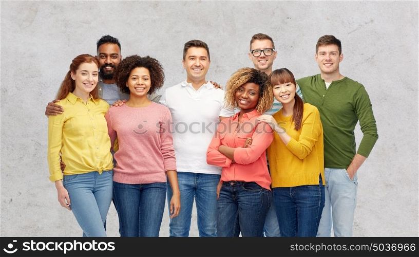 diversity, race, ethnicity and people concept - international group of happy smiling men and women over gray background. international group of happy smiling people