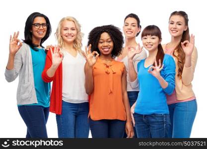 diversity, race, ethnicity and people concept - international group of happy smiling different women over white showing ok hand sign. international group of happy women showing ok