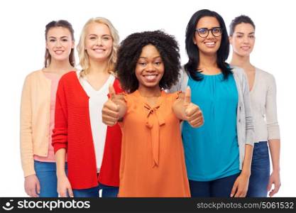 diversity, race, ethnicity and people concept - international group of happy smiling different women over white showing thumbs up. international group of women showing thumbs up