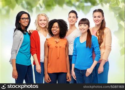 diversity, race, ethnicity and people concept - international group of happy smiling different women over green natural background. international group of happy smiling women