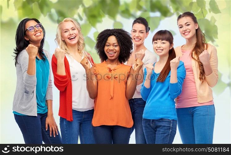 diversity, race, ethnicity and people concept - international group of happy smiling different women celebrating success over green natural background. international group of happy smiling women