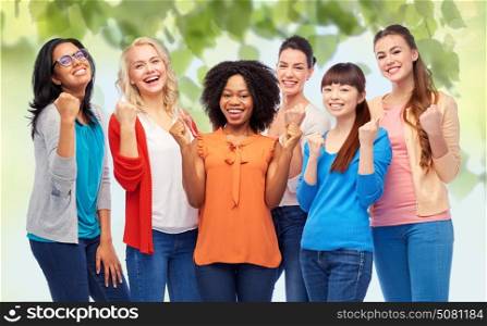 diversity, race, ethnicity and people concept - international group of happy smiling different women celebrating success over green natural background. international group of happy smiling women