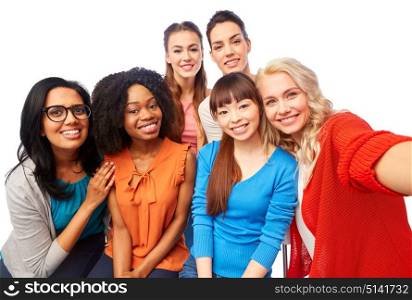 diversity, race, ethnicity and people concept - international group of happy smiling different women over white hugging and taking selfie. international group of happy women taking selfie