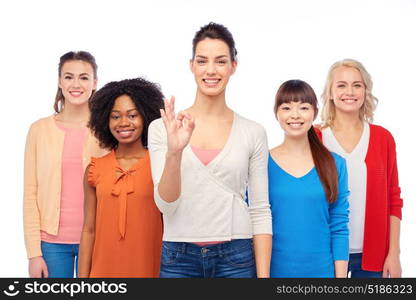 diversity, race, ethnicity and people concept - international group of happy smiling different women over white showing ok hand sign. international group of happy women showing ok