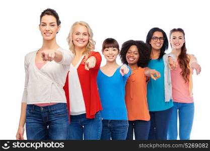 diversity, race, ethnicity and people concept - international group of happy smiling different women over white pointing finger at you. international group of happy smiling women