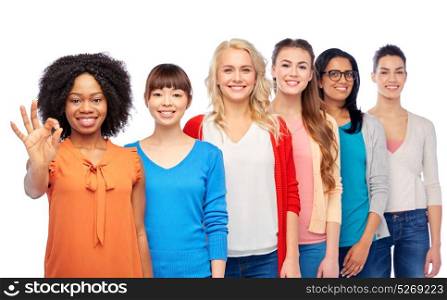 diversity, race, ethnicity and people concept - international group of happy smiling different women over white showing ok hand sign. international group of happy women showing ok