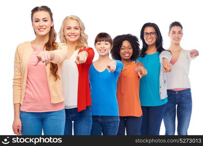 diversity, race, ethnicity and people concept - international group of happy smiling different women over white pointing finger at you. international group of happy smiling women