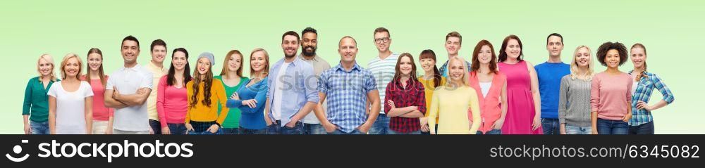 diversity, race, ethnicity and people concept - international group of happy smiling men and women over green background. international group of happy smiling people