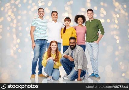 diversity, race, ethnicity, friendship and people concept - international group of happy smiling men and women over lights background
