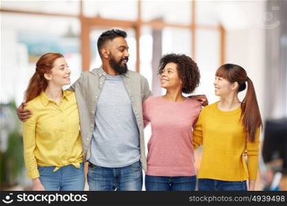 diversity, race, ethnicity, friendship and people concept - international group of happy smiling men and women over office background. international group of happy smiling people