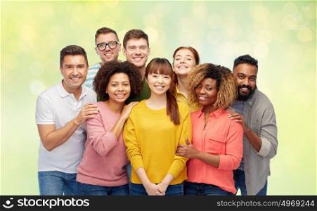 diversity, race, ethnicity, friendship and people concept - international group of happy smiling men and women over summer green lights background. international group of happy smiling people