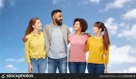 diversity, race, ethnicity, friendship and people concept - international group of happy smiling men and women over blue sky and clouds background. international group of happy smiling people