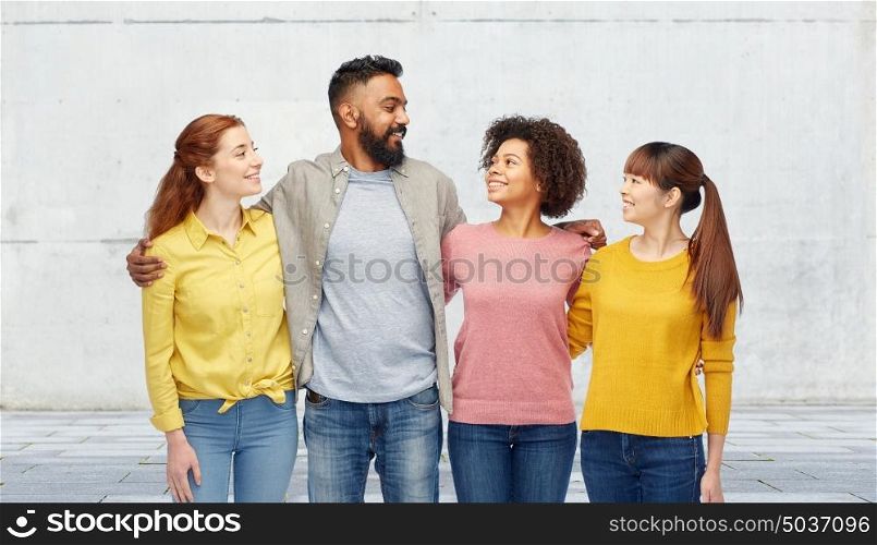 diversity, race, ethnicity, friendship and people concept - international group of happy smiling men and women over stone wall background. international group of happy smiling people