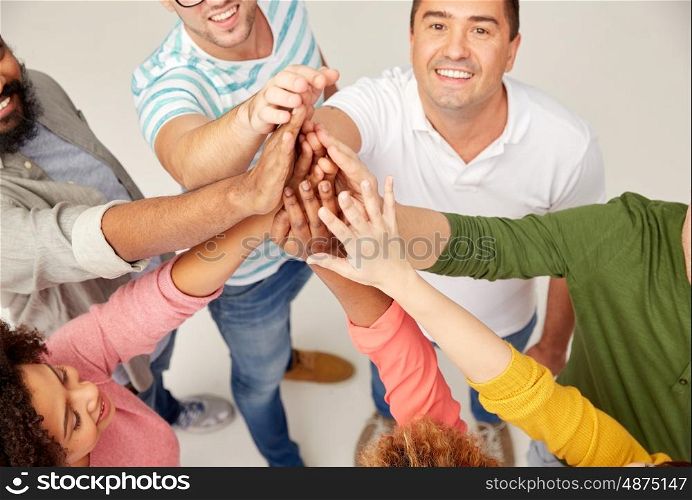 diversity, race, ethnicity, gesture and people concept - international group of happy smiling men and women making high five