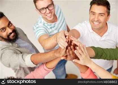 diversity, race, ethnicity, gesture and people concept - international group of happy smiling men and women making high five. international group of people making high five