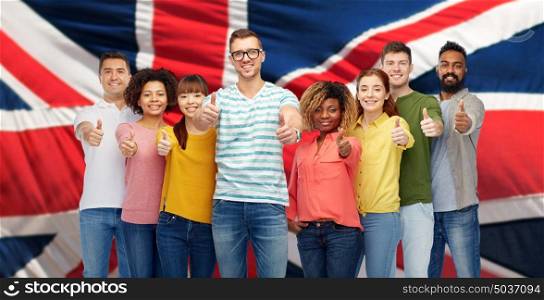diversity, race, ethnicity, immigration and people concept - international group of happy smiling men and women showing thumbs up over english flag background. people showing thumbs up over english flag