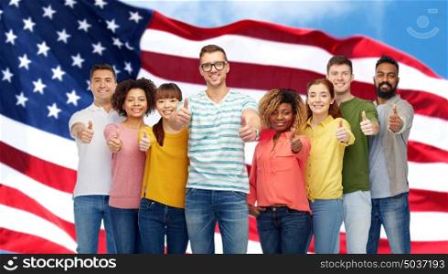 diversity, race, ethnicity, immigration and people concept - international group of happy smiling men and women showing thumbs up over american flag background. happy people showing thumbs up over american flag