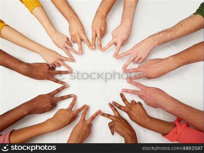 diversity, race, ethnicity, international and people concept - group of hands showing peace hand sign