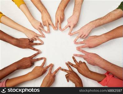diversity, race, ethnicity, international and people concept - group of hands showing peace hand sign