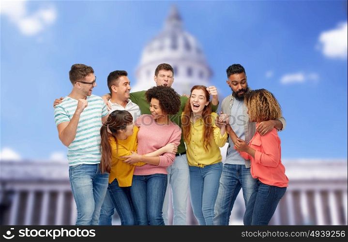 diversity, race, ethnicity, success and people concept - international group of happy smiling men and women celebrating victory over united states capitol background. international group of happy smiling people