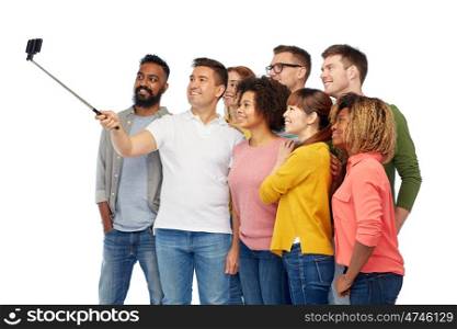 diversity, race, ethnicity, technology and people concept - international group of happy smiling men and women taking picture by smartphone selfie stick over white
