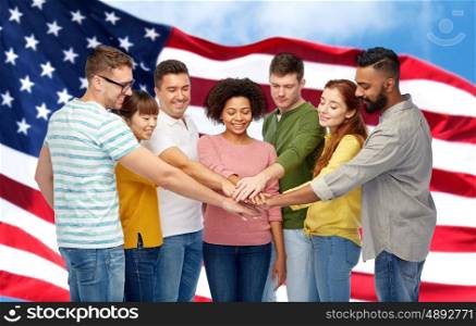 diversity, teamwork, race, ethnicity and people concept - international group of happy smiling men and women holding hands together over american flag background