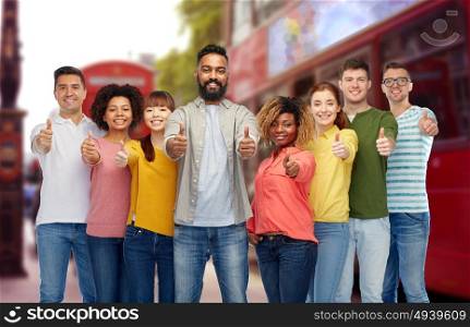 diversity, travel, tourism and people concept - international group of happy smiling men and women showing thumbs up over london street and city bus background. international people showing thumbs up at london
