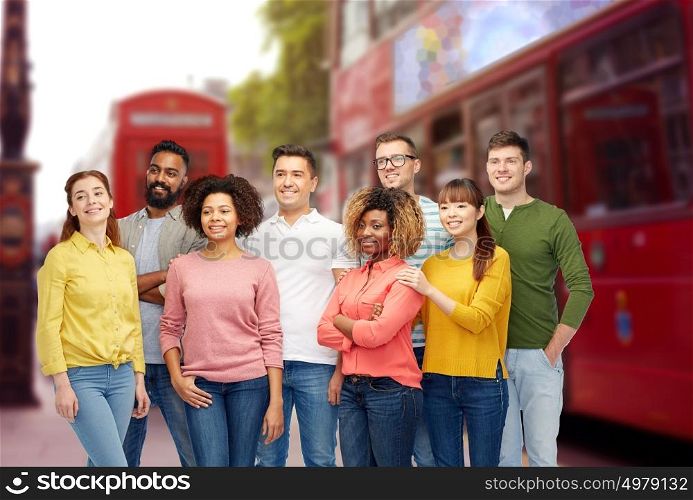 diversity, travel, tourism and people concept - international group of happy smiling men and women over london street and city bus background. international group of people over london city