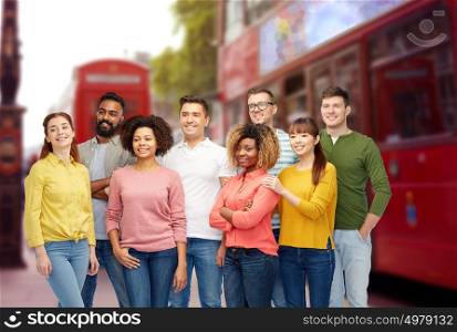 diversity, travel, tourism and people concept - international group of happy smiling men and women over london street and city bus background. international group of people over london city