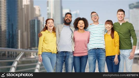 diversity, travel, tourism and people concept - international group of happy smiling men and women over dubai city background. international group of happy people in dubai