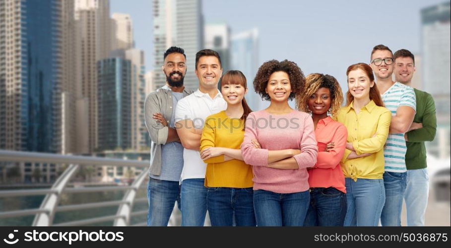 diversity, travel, tourism and people concept - international group of happy smiling men and women over dubai city background. international group of happy people in dubai