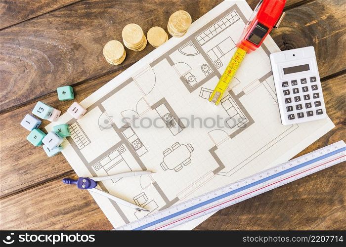 divider ruler math blocks calculator stacked coins blueprint wooden desk