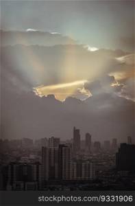 Divine glow through the Clouds of the Morning or Evening warm Sun over Large Metropolitan city with Skyscrapers on Background. The Stunning Beauty of a Sunrise or Sunset, They can be used as Wallpaper that look Amazing, Space for text, Selective focus.