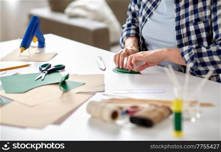 diy, art and hobby concept - close up of woman making paper craft at home. woman making paper craft at home