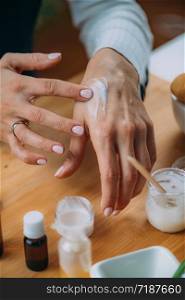 DIY Cream at Home - Woman Applying Homemade Hand Cream onto her Hands. Woman Applying Homemade Hand Cream onto her Hands
