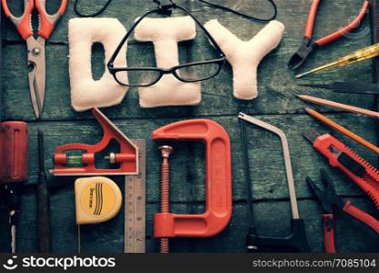 Diy tools background with group of crafting tools like scissors, hammer, knife, equipment for handmade product on wood background, a hobby of dad to repair in home