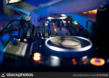 Dj mixing at party festival with light and smoke in background - Summer nightlife view of disco club inside.High quality photography.. Dj mixing at party festival with light and smoke in background - Summer nightlife view of disco club inside.