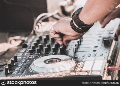 DJ plays and mix music on digital midi mixer controller