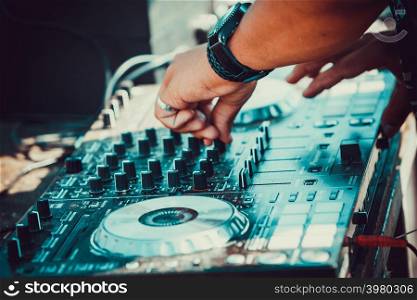 DJ plays and mix music on digital midi mixer controller