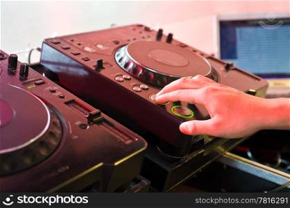 DJ with his hands on the buttons of a turntable