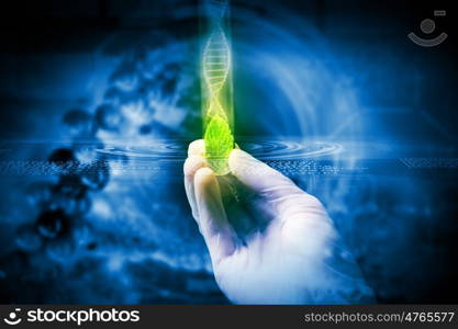 DNA molecule. Close up image of human hand holding test tube. Science concept