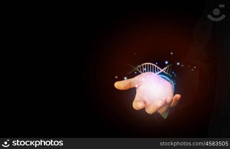 Dna molecule. Close up of man holding DNA molecule in palm