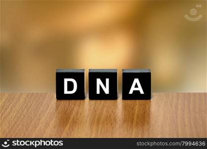 DNA or Deoxyribonucleic Acid on black block with blurred background