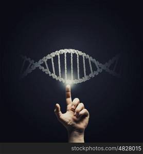 DNA research. Science concept image of human hand touching DNA molecule
