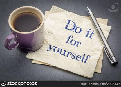 Do it for yourself advice on napkin. Do it for yourself advice - handwriting on a napkin with cup of coffee against gray slate stone background